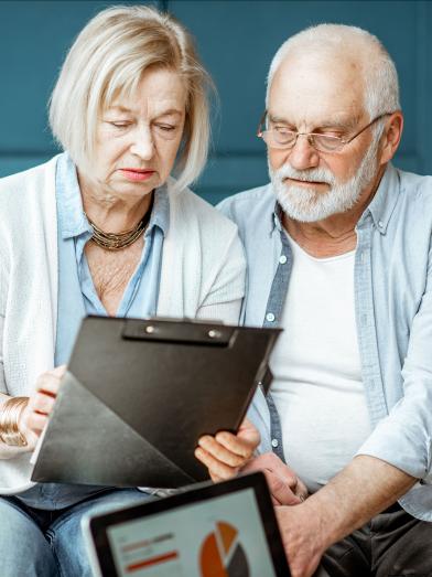 Senior husband and wife looking at chart