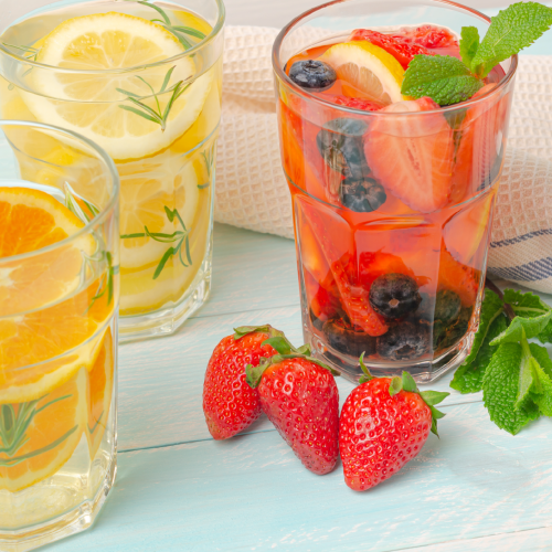3 glasses of lemonade and one with strawberries and blueberries