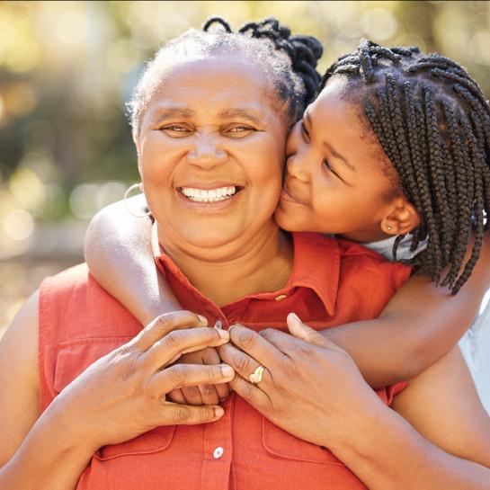 Smiling African American grandmother and granddaughter