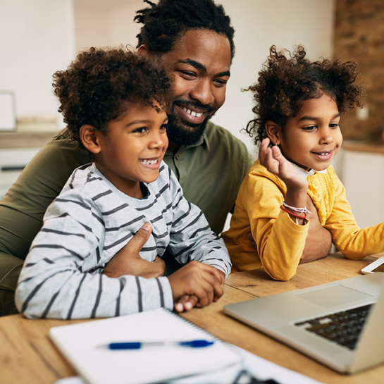 Happy father and children watching computer