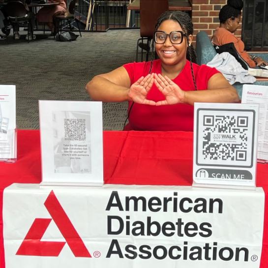 Smiling ADA volunteer at ADA booth