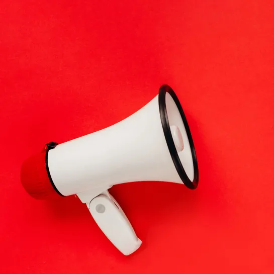Megaphone on red background