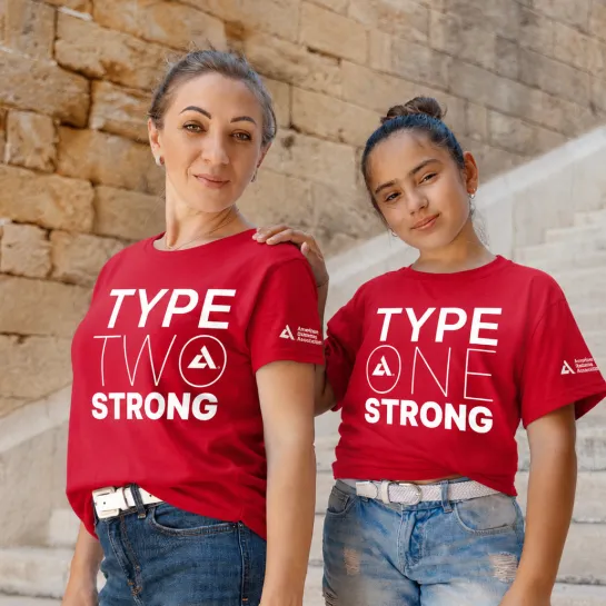 Adult woman and child in red shirts: "TYPE TWO STRONG" and "TYPE ONE STRONG".