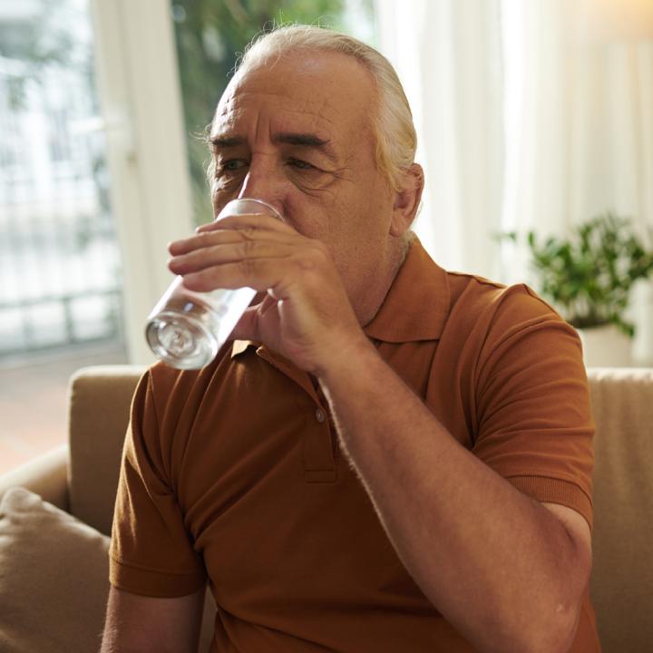 Senior man drinking glass of water