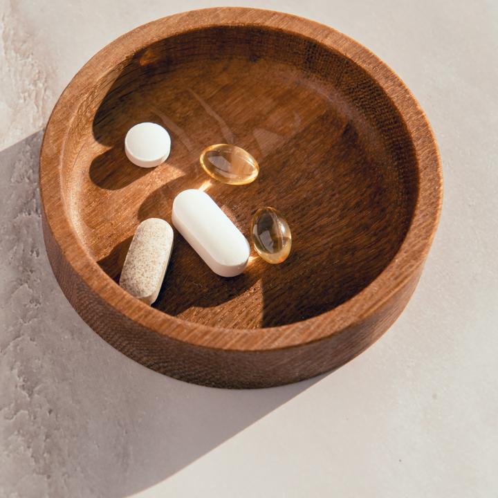 Pills in a wooden bowl