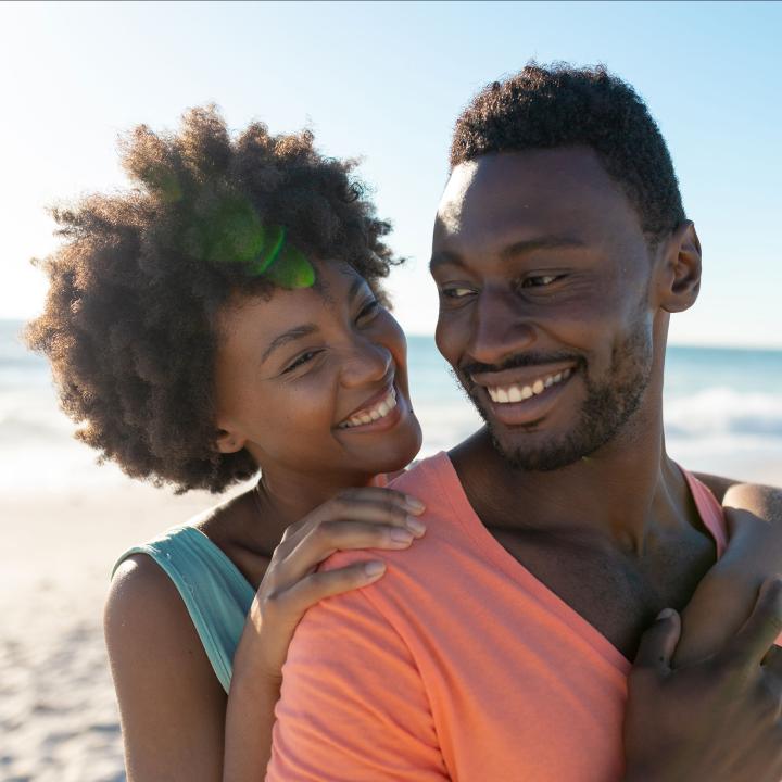 Happy African American couple on the beach
