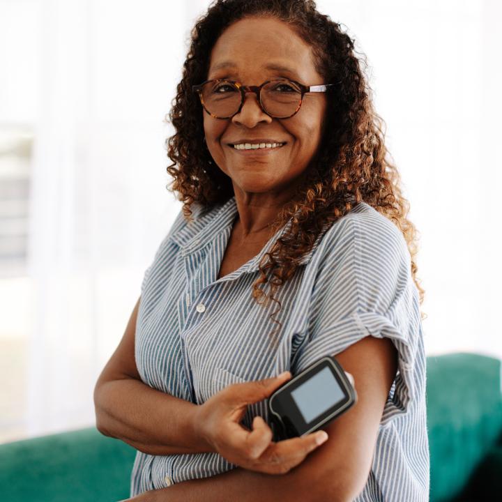 Senior African American woman checking her cgm