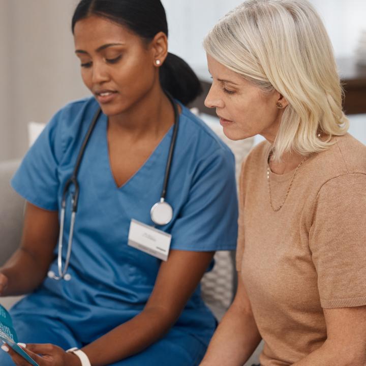 Shot of a doctor reading a pamphlet about covid