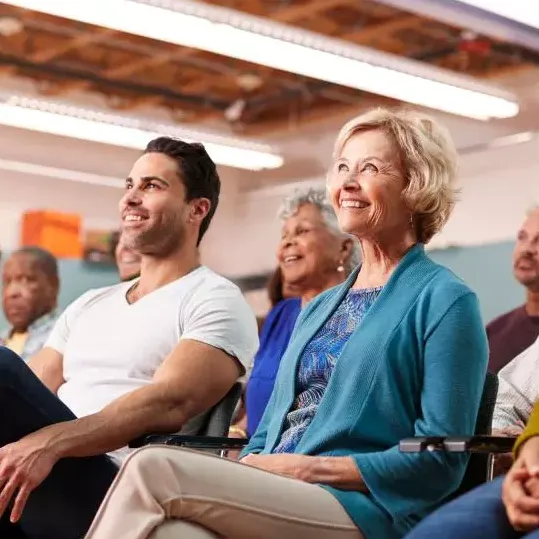 Diverse group of men and women listening to a speaker