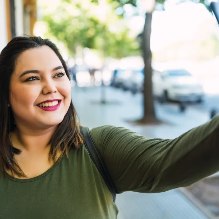 Smiling young woman taking a selfie picture