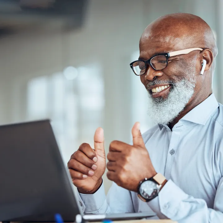 Comms humbs up laptop and african businessman on online