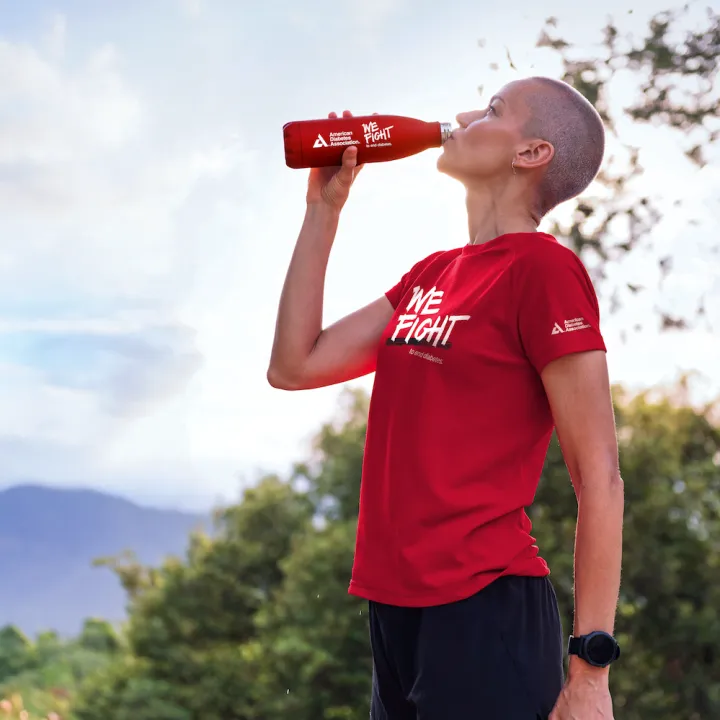 Woman in red ADA we fight shirt drinking from an ADA water bottle