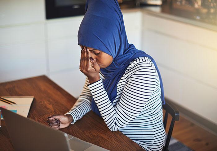 young-arabic-woman-entrepreneur-at-desk-laptop-computer-blue-scarf