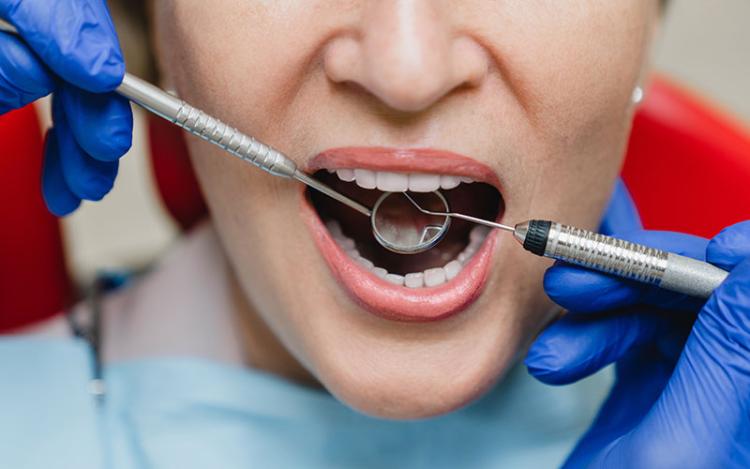 Close-up of woman in dentist chair having her gums examined