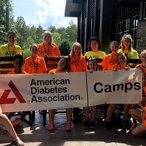 Kids holding up American Diabetes Association camp banner