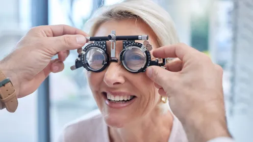 Smiling senior woman getting eye exam