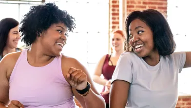 Two smiling women at exercise class