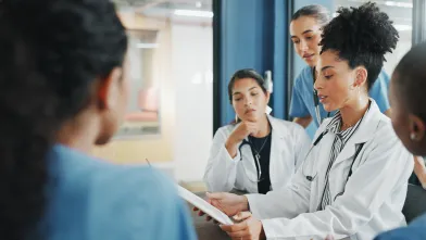 Team of doctors reviewing document