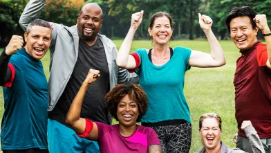 Smiling group of enthusiastic exercisers outside