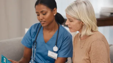 Shot of a doctor reading a pamphlet about covid