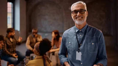 Smiling man leading group discussion