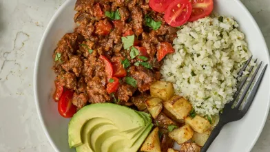 Beef mushroom taco bowl with avocaco, potatoes, and rice