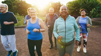 Smiling group of senior men and women out for an early morning walk.