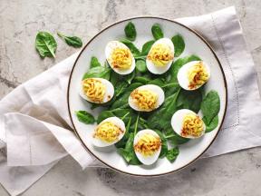 Plate with deviled eggs over bed of spinach