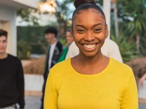 Smiling young African American Woman in bright yellow shirt