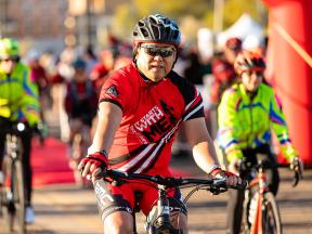 Senior man on bicycle at fundraising ride for diabetes