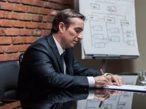 Business man writing on memo pad