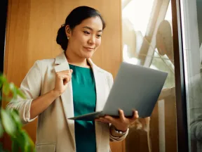 Asian woman holding a laptop computer