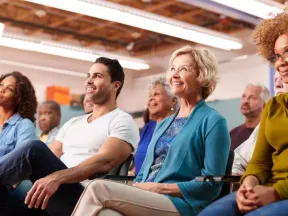 Diverse group of men and women listening to a speaker