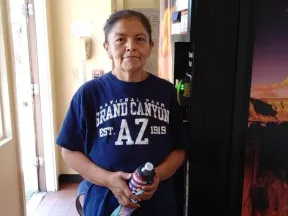 A woman standing next to a vending machine