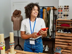 young hispanic saleswoman with tablet working in store