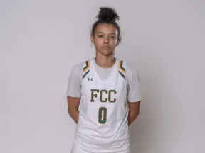 Female athlete in white "FCC 0" basketball uniform.