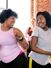 Two smiling women at exercise class