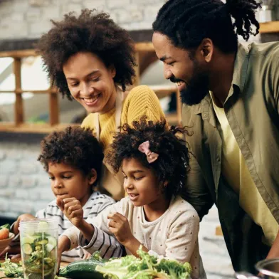 Happy African American family preparing dinner in kitchen