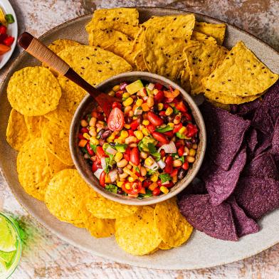 Corn cowboy caviar surrounded by corn chips
