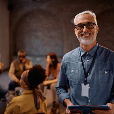 Smiling man leading group discussion
