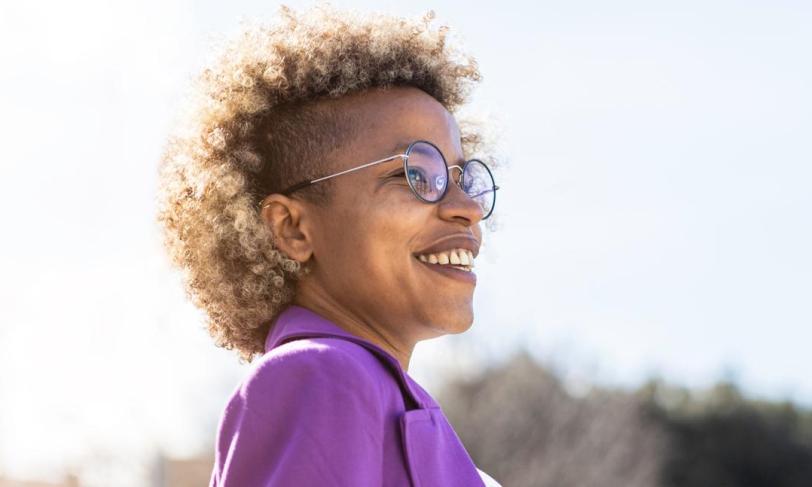 African american woman wearing glasses outdoors smiling
