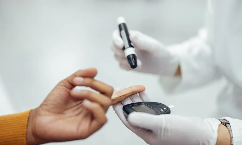 Close-up of person getting blood glucose tested with lancet