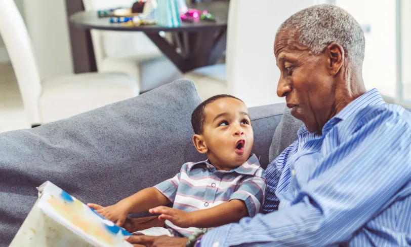 Grandfather on couch with grandson 