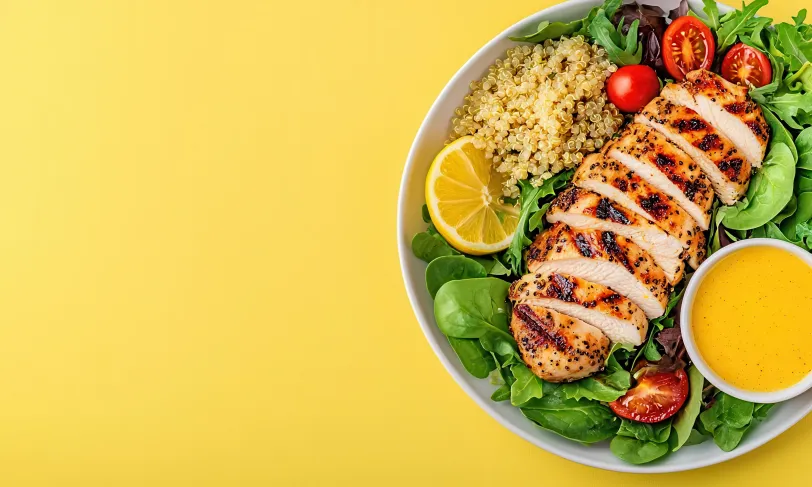 Grilled chicken breast salad in bowl.