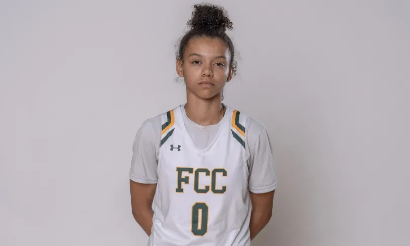 Female athlete in white "FCC 0" basketball uniform.