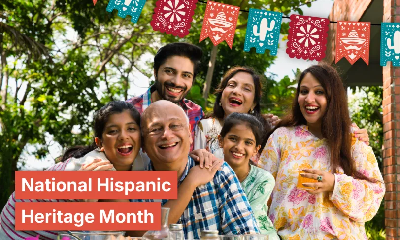 Smiling Hispanic family celebrates outdoors. Text: National Hispanic Heritage Month.