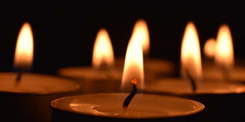 Group of lit candles at night