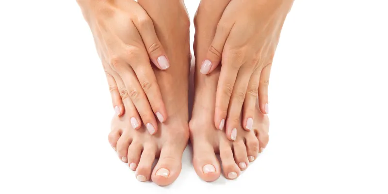 Woman rubbing her feet with her hands
