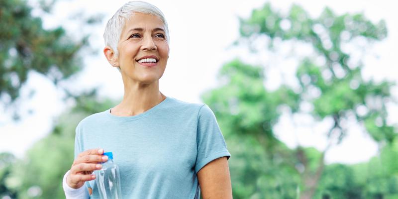 Senior woman in park with water bottle