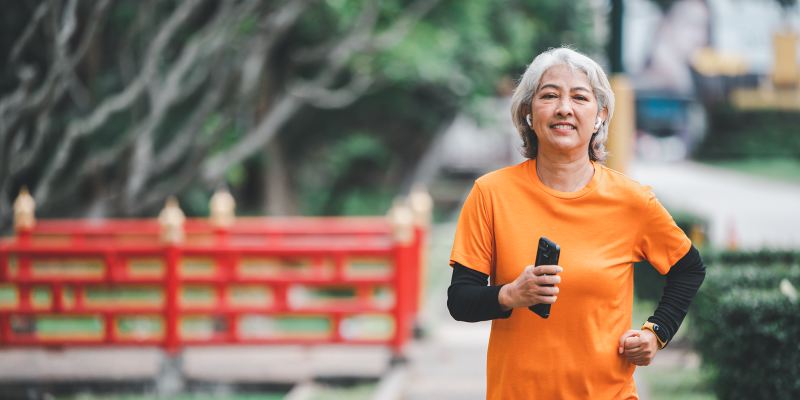 white haired elderly person exercising in the park